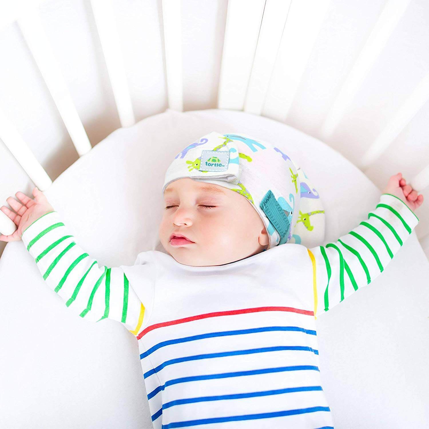 Baby use Tortle repositioning beanie to treat flat head syndrome cause by preference to sleep on one side