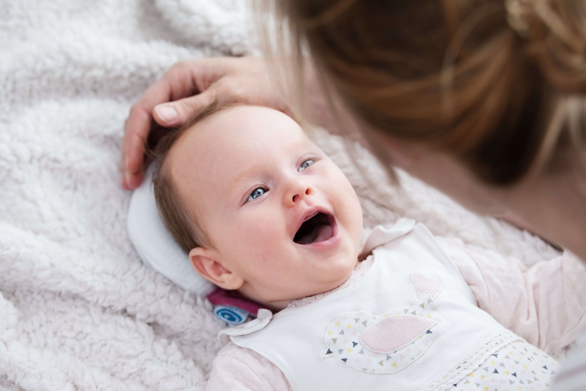 Happy baby girl on Medibino cushion