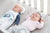 twin baby boy sleep on Medibino pillow in the cot